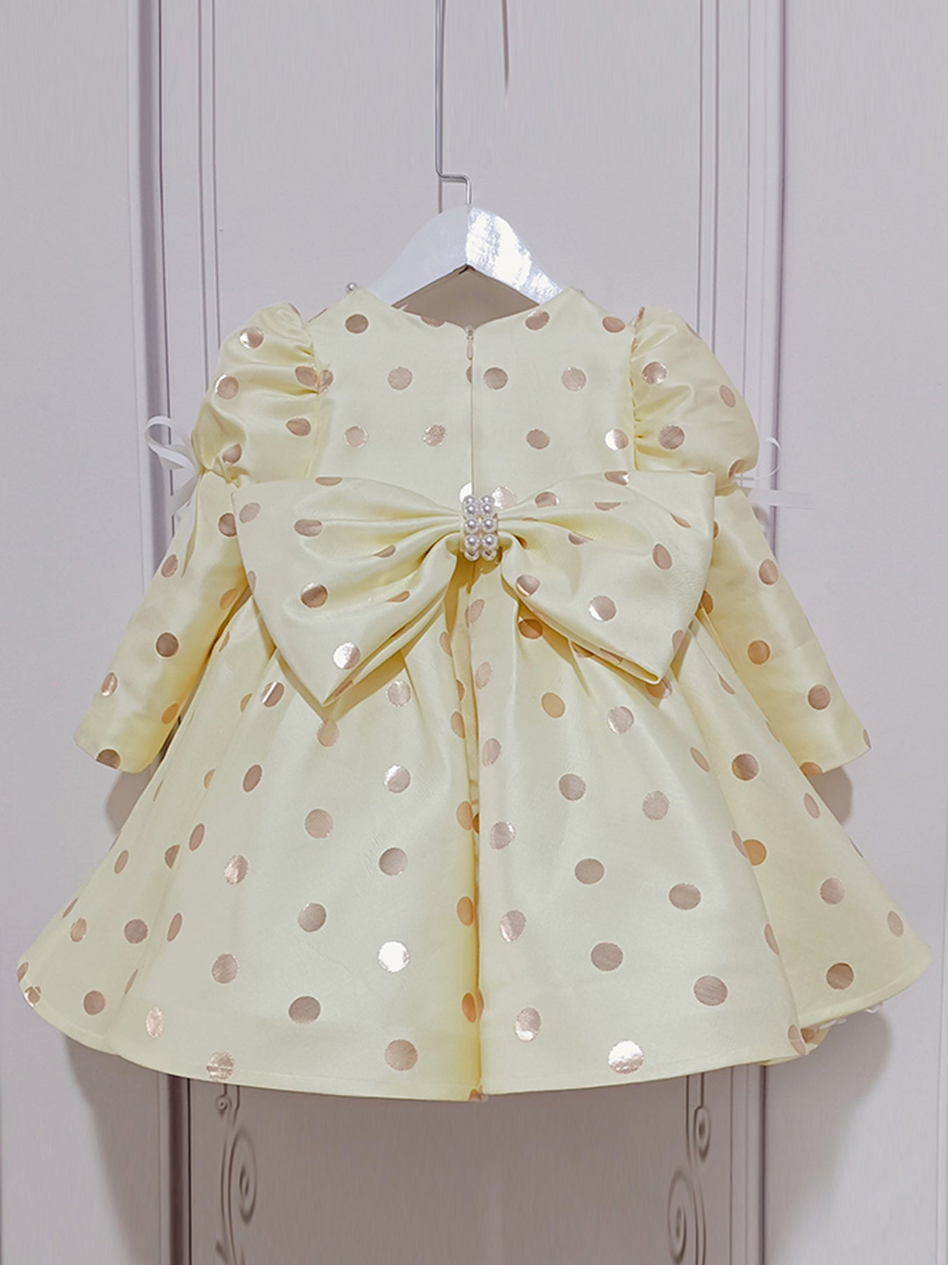 A gold polka dot princess dress